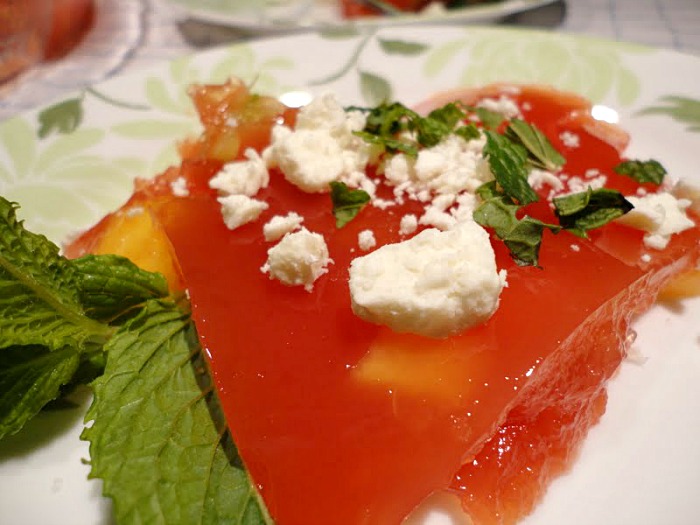 Watermelon Jello salad is a delicious summer salad recipe. Fresh fruit is added to made-from-scratch watermelon Jello, then topped with feta and fresh mint.