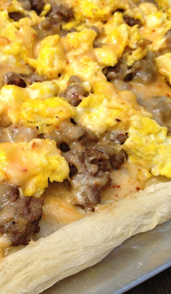 This sausage breakfast pizza recipe uses a combination of fresh Italian pork sausage, scrambled eggs, and chipotle cheddar cheese. A fun way to have pizza for breakfast! | Basilmomma.com