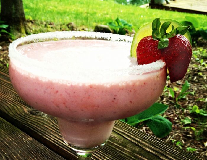Fizzy Strawberry Margaritas in a margarita glass. Get the recipe on basilmomma.com
