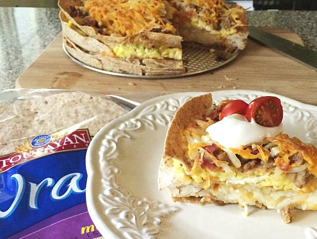 Breakfast Lasagna- Move over bacon, eggs and potatoes! Layer Toufayan Bakeries multi-grain wraps, eggs, bacon, sausage, potatoes, and cheese for a healthy and hearty breakfast! - Get the recipe on basilmomma.com