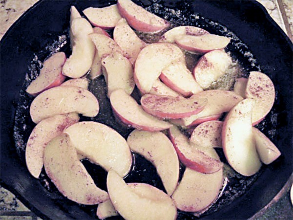 Apples cooking to make an apple skillet pancake.