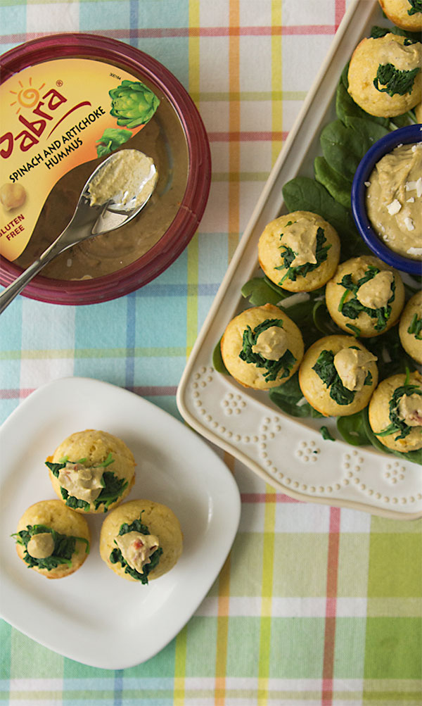 Spinach Artichoke Hummus Corn Muffins, topped with sauteed garlic-spinach and a dollop of Sabra spinach artichoke hummus | gluten free | healthy appetizer | sponsored by @sabra