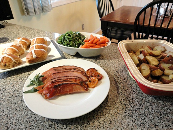 Complete Easter dinner, including tangerine glazed ham, garlic green beans, herb roasted potatoes, and hot cross buns.