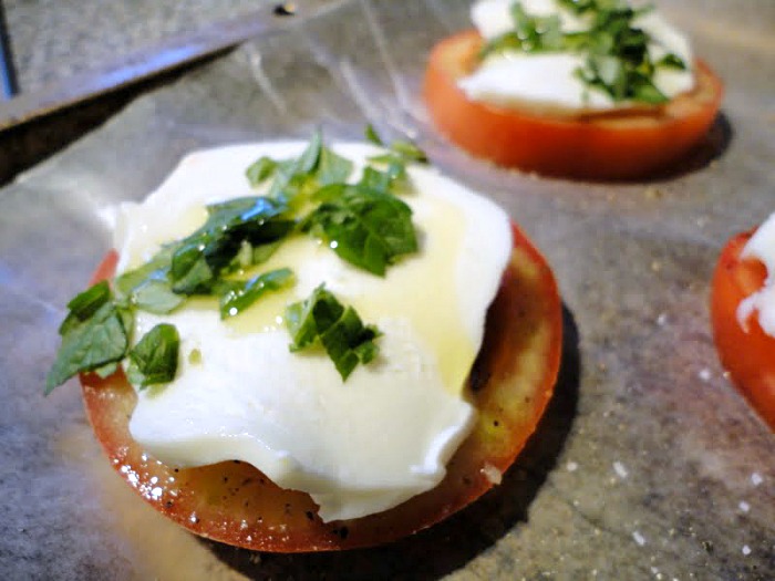 This baked caprese appetizer is a quick and easy way to use fresh garden tomatoes! Juicy garden tomatoes, fresh basil, and soft mozzarella cheese are all you need to make this great appetizer or side dish!
